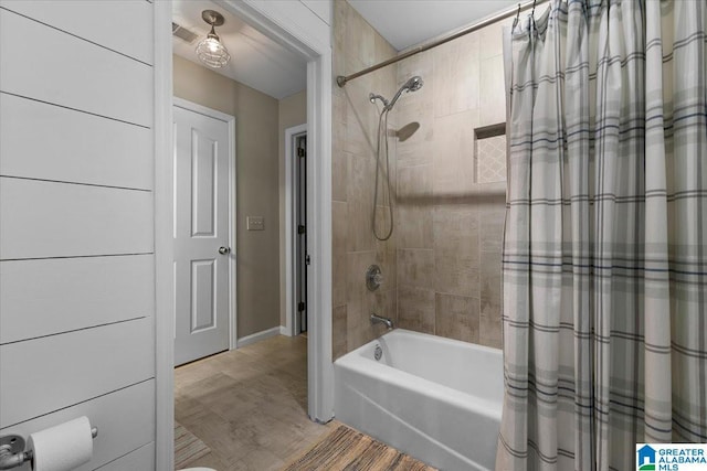 bathroom featuring visible vents and shower / bath combo with shower curtain