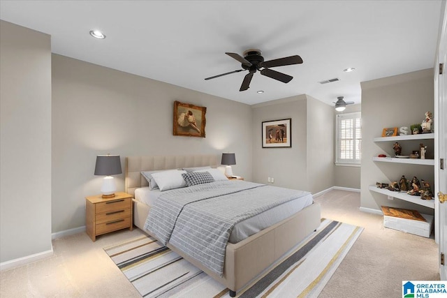 bedroom with baseboards, a ceiling fan, visible vents, and light colored carpet