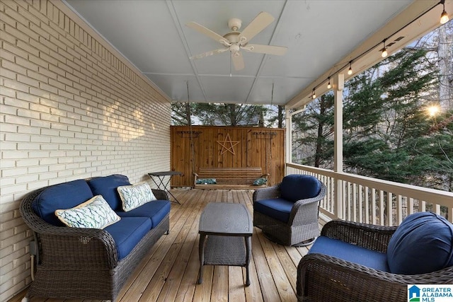 wooden terrace featuring ceiling fan and outdoor lounge area