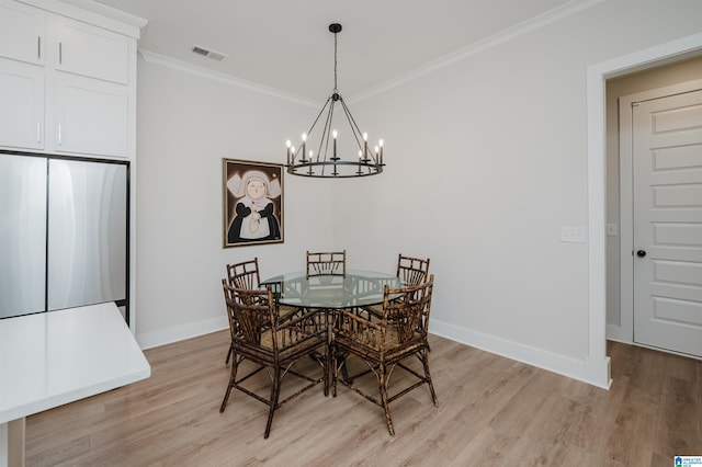 dining space featuring light wood-type flooring, visible vents, and crown molding