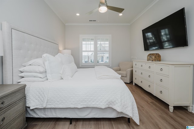 bedroom featuring visible vents, a ceiling fan, wood finished floors, crown molding, and recessed lighting