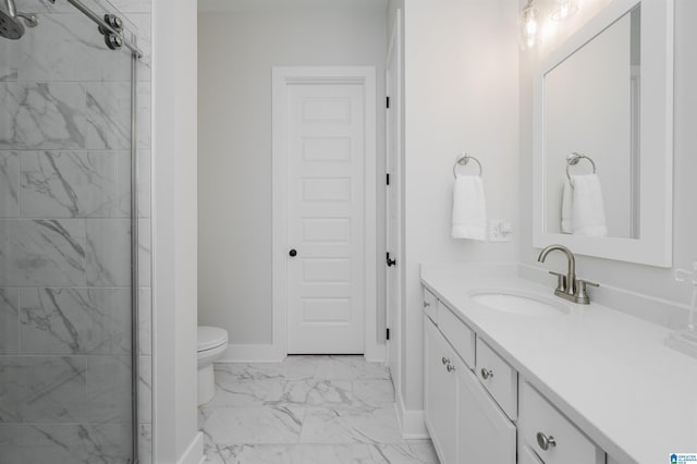 bathroom with toilet, vanity, baseboards, marble finish floor, and tiled shower