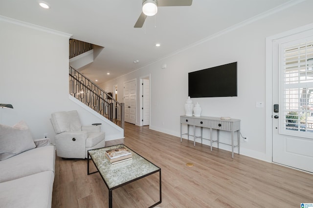 living area with stairway, baseboards, ornamental molding, and wood finished floors