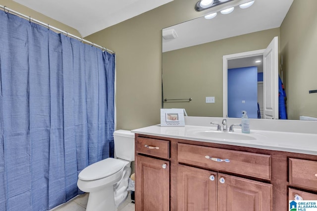 bathroom featuring vanity, toilet, and tile patterned flooring