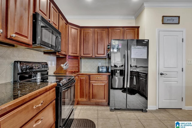 kitchen featuring crown molding, light tile patterned floors, decorative backsplash, brown cabinetry, and black appliances