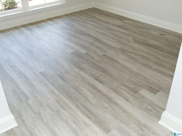 interior details featuring wood finished floors and baseboards