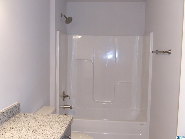 full bath with shower / tub combination, vanity, and toilet