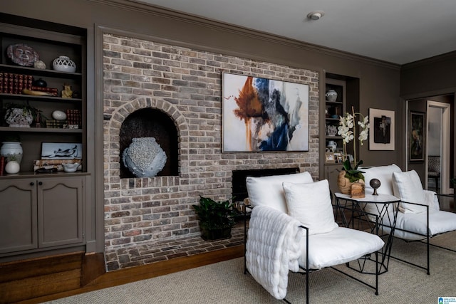 sitting room featuring built in features, a fireplace, carpet, and ornamental molding