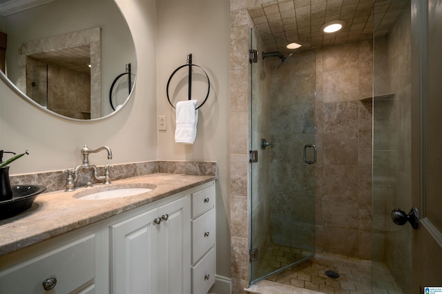 bathroom with a stall shower and vanity