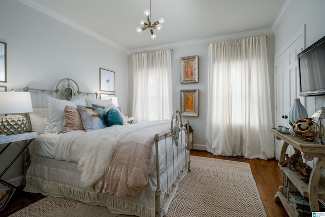 bedroom with wood finished floors, a notable chandelier, and ornamental molding