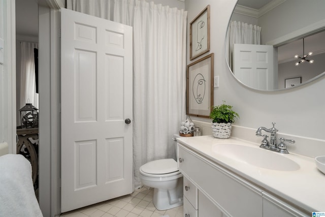 bathroom featuring vanity, tile patterned floors, toilet, and crown molding