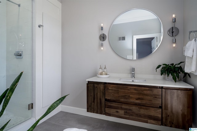 full bathroom featuring vanity, baseboards, visible vents, a stall shower, and tile patterned flooring