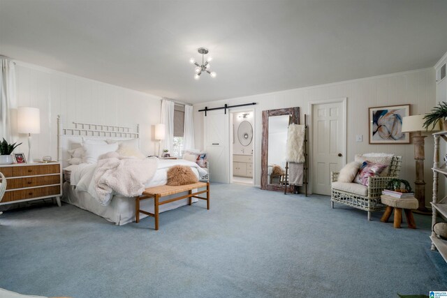 bedroom featuring connected bathroom, crown molding, a chandelier, a barn door, and carpet floors