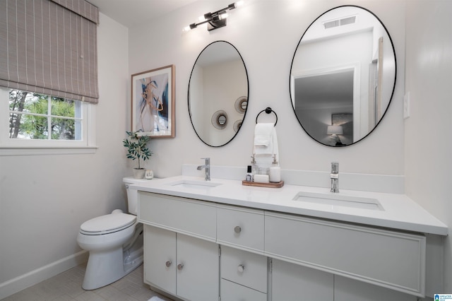 full bath featuring a sink, visible vents, toilet, and double vanity