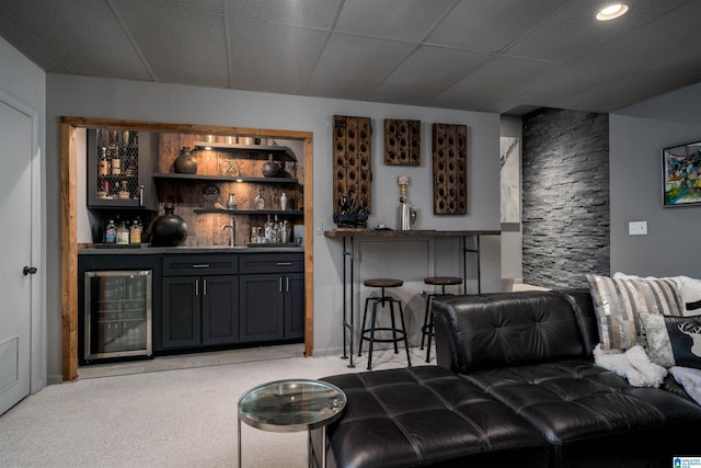 bar featuring wet bar, beverage cooler, and light carpet