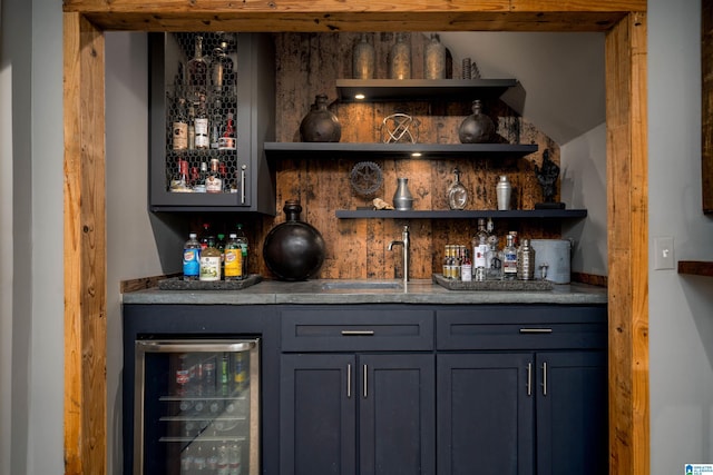 bar featuring wine cooler and wet bar