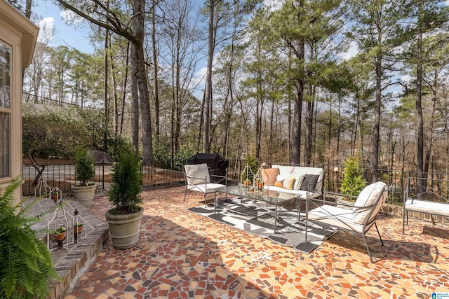 view of patio / terrace featuring an outdoor living space and fence