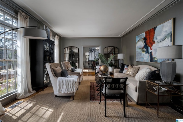 living room with visible vents and crown molding