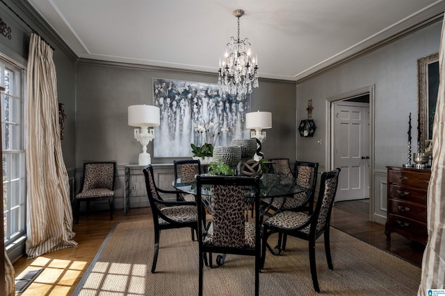 dining area with visible vents, an inviting chandelier, wood finished floors, and crown molding