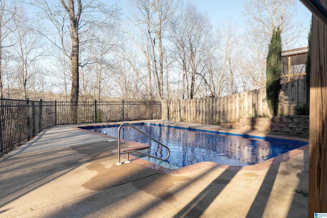 view of swimming pool featuring a patio area, a fenced in pool, and a fenced backyard