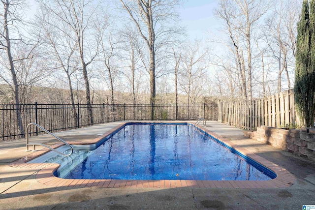 view of swimming pool with a patio area, fence, and a fenced in pool