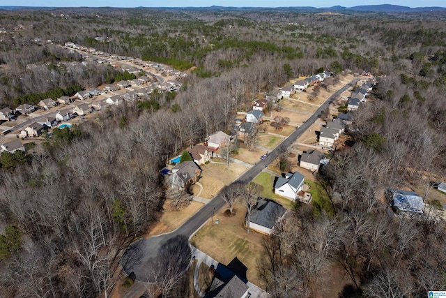 drone / aerial view featuring a wooded view