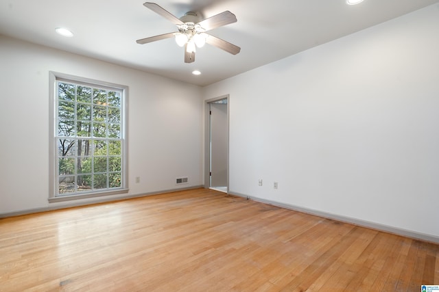 spare room featuring visible vents, light wood-style flooring, a ceiling fan, recessed lighting, and baseboards