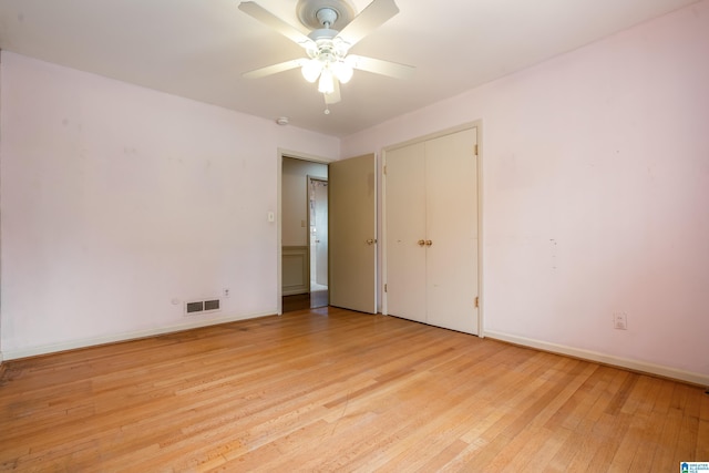 unfurnished room with ceiling fan, baseboards, visible vents, and light wood-type flooring