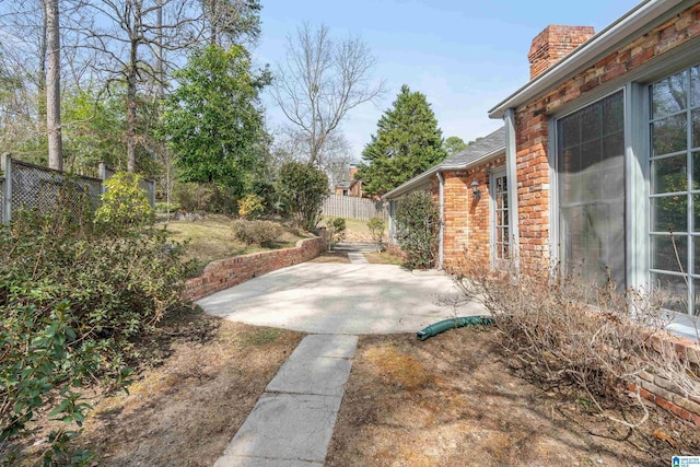 view of yard featuring a patio and fence