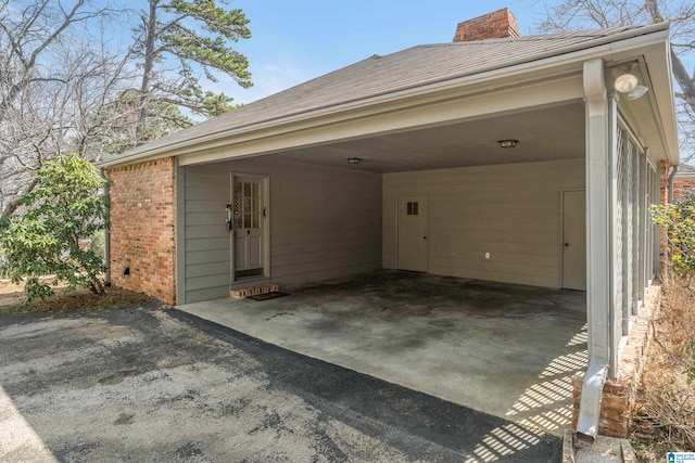 exterior space with an attached carport and driveway