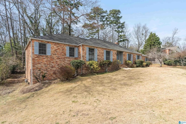 single story home with brick siding and a front yard