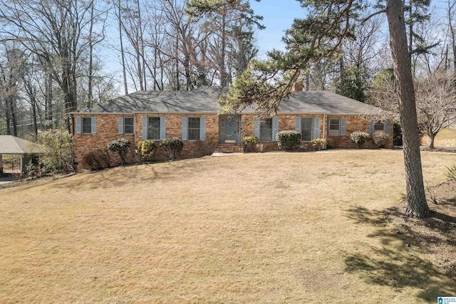 ranch-style home with brick siding and a front lawn