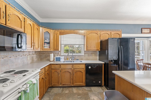 kitchen featuring ornamental molding, a sink, black appliances, and wallpapered walls