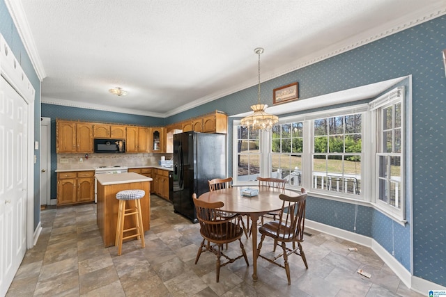 kitchen with brown cabinets, light countertops, an inviting chandelier, black appliances, and wallpapered walls