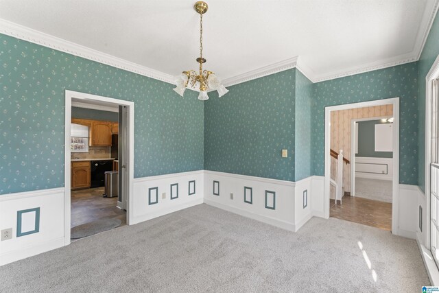 spare room with a wainscoted wall, carpet flooring, and wallpapered walls