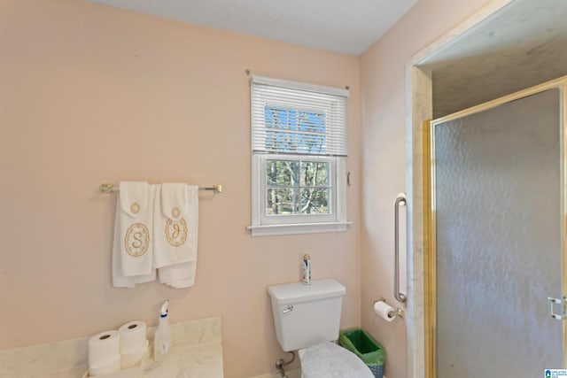 full bathroom featuring toilet and a stall shower