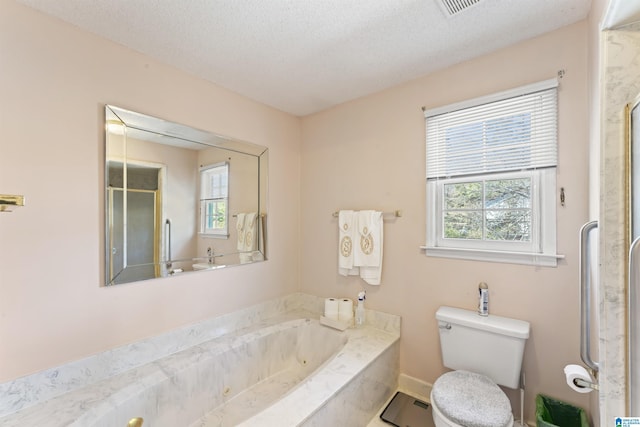 full bathroom with a textured ceiling, a whirlpool tub, a shower stall, and toilet