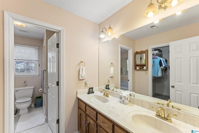 bathroom featuring visible vents, a sink, and toilet