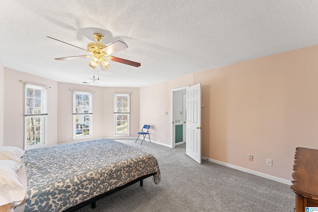 carpeted bedroom with a ceiling fan, a textured ceiling, and baseboards