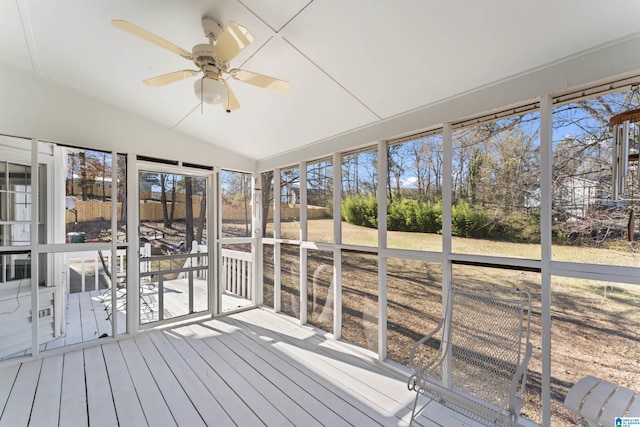 unfurnished sunroom featuring lofted ceiling and ceiling fan