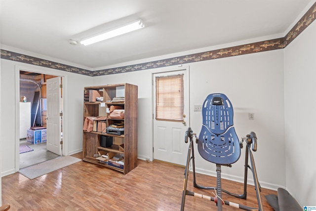 miscellaneous room featuring light wood-type flooring and baseboards