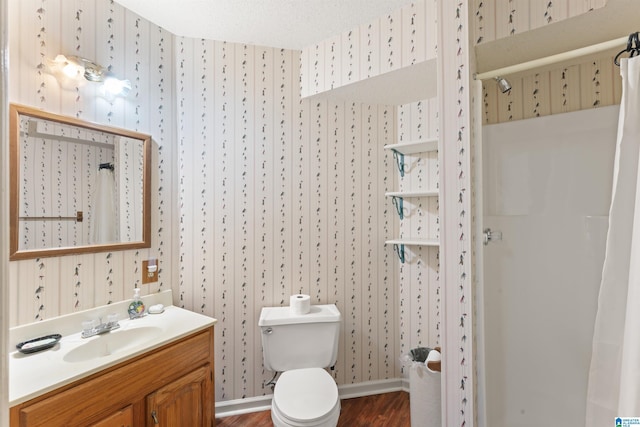 bathroom featuring a textured ceiling, toilet, a shower with shower curtain, vanity, and wallpapered walls