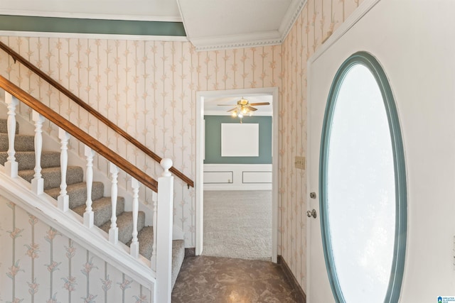 stairway with carpet floors, wallpapered walls, and wainscoting