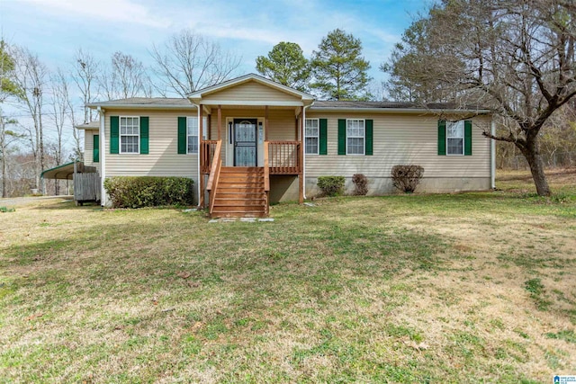 view of front of property with a porch, a front lawn, and a detached carport