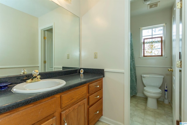 bathroom with tile patterned flooring, visible vents, vanity, and toilet