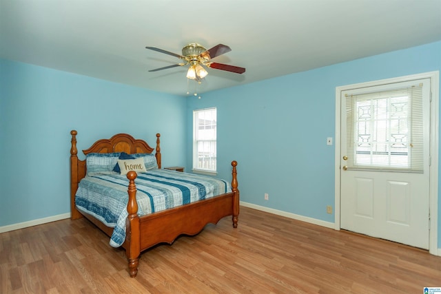 bedroom featuring baseboards, ceiling fan, and light wood-style floors