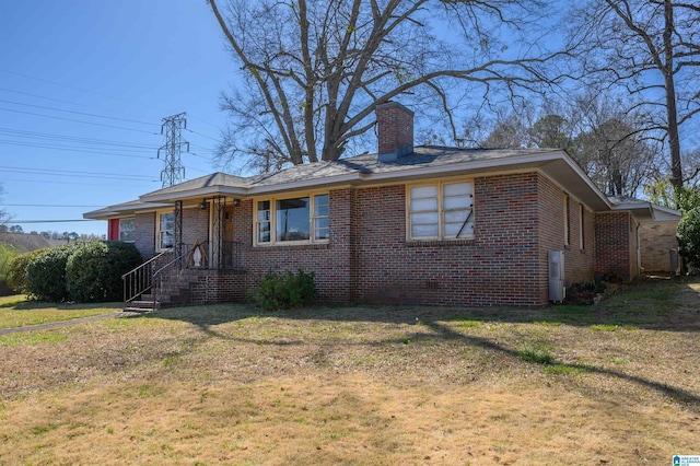 bungalow-style house featuring a front lawn, brick siding, and a chimney