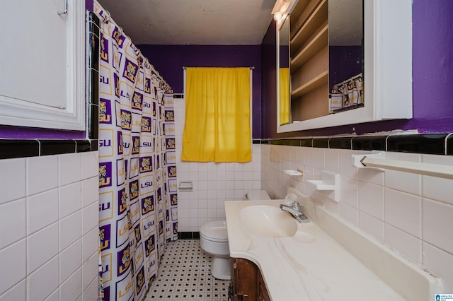 full bath featuring curtained shower, toilet, tile walls, and vanity