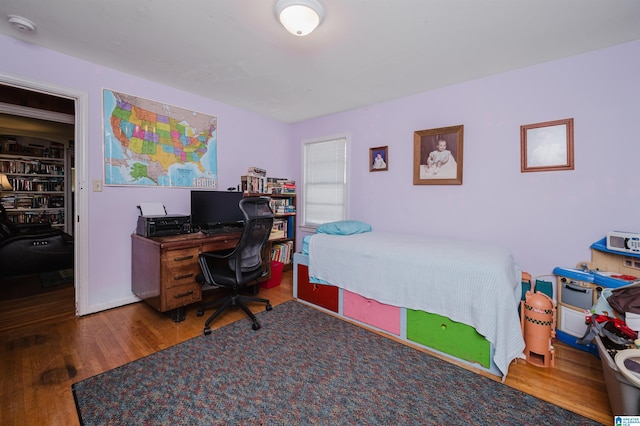 bedroom with wood finished floors