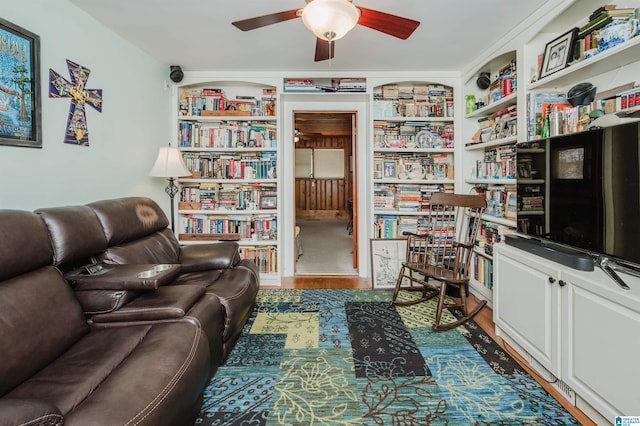 interior space with wood finished floors and a ceiling fan